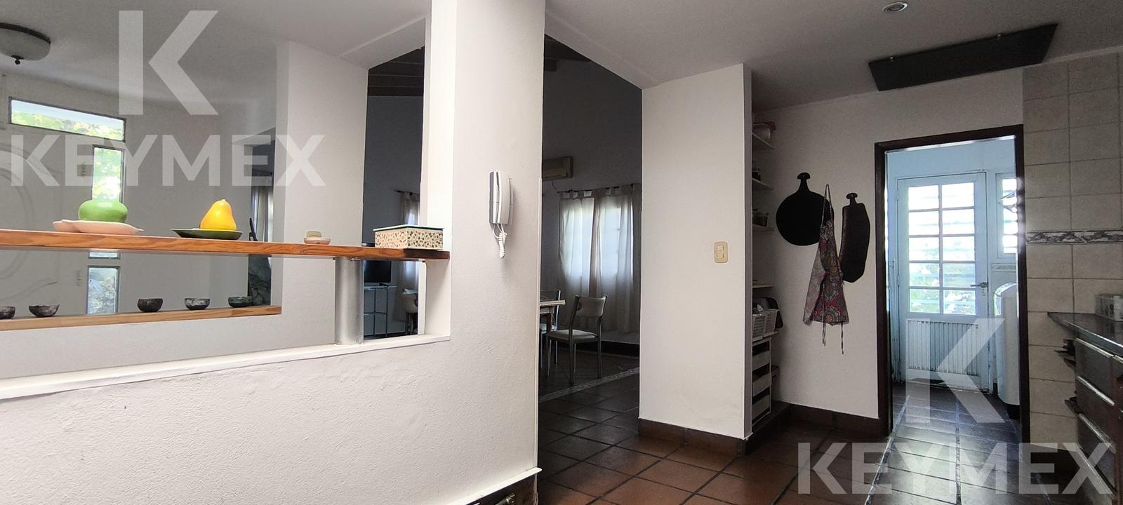 Cocina equipada con muebles bajo mesada y campana extractora