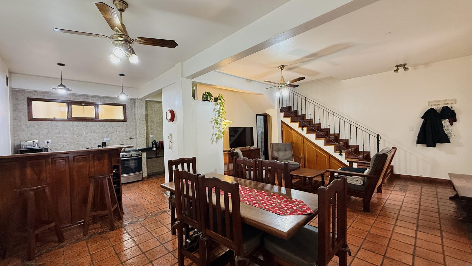 living, escalera y acceso a baño completo