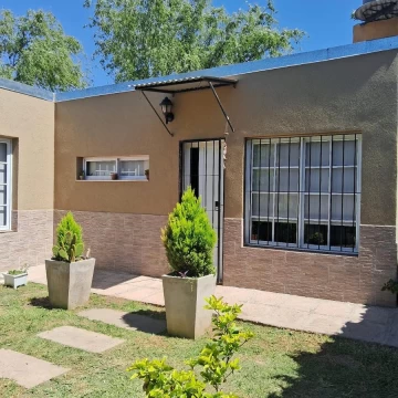 Casa de dos dormitorios con cocina integrada al living comedor, 1 baño, cochera y amplio patio.