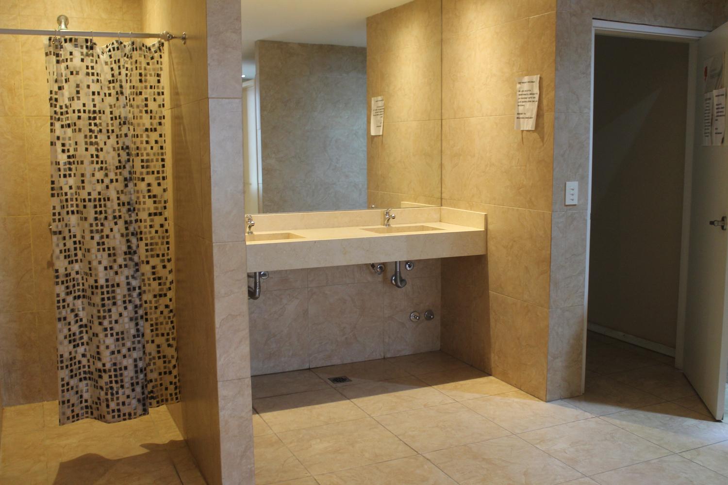 Vestuario con duchas al lado de pileta